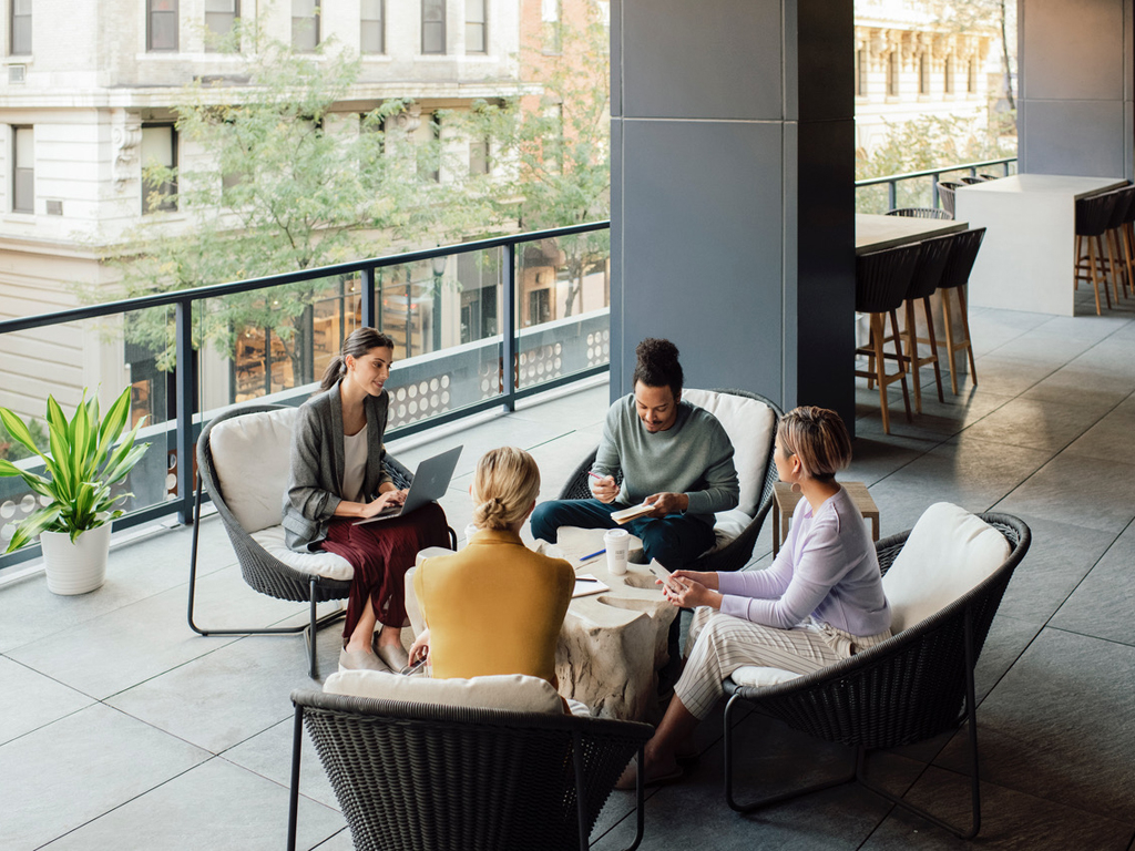 A diverse team collaborating in a sunlit office